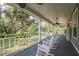 Relaxing front porch with rocking chairs and a view of the surrounding landscape at 7545 Ne 58Th Ave, Anthony, FL 32617