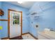 Bright laundry room with utility sink, built-in shelving and exterior access at 7545 Ne 58Th Ave, Anthony, FL 32617