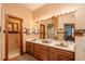 Double vanity bathroom with a toilet and access to another room at 7545 Ne 58Th Ave, Anthony, FL 32617
