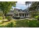 Two-story home with wraparound porch and landscaped yard at 7545 Ne 58Th Ave, Anthony, FL 32617