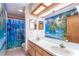 Bathroom with double vanity and tropical mural at 7545 Ne 58Th Ave, Anthony, FL 32617