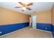 Bedroom with blue and tan walls and ceiling fan at 7545 Ne 58Th Ave, Anthony, FL 32617