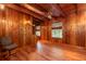 Spacious wood paneled office with hardwood floors and large windows at 7545 Ne 58Th Ave, Anthony, FL 32617