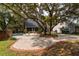 Landscaped backyard with pool and large oak tree at 7545 Ne 58Th Ave, Anthony, FL 32617