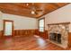 Living room featuring hardwood floors, wood ceiling, and a stone fireplace at 7545 Ne 58Th Ave, Anthony, FL 32617