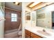 Bathroom with shower/tub combo and wood vanity at 7545 Ne 58Th Ave, Anthony, FL 32617