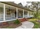 Spacious front porch with rocking chairs and brick steps at 7545 Ne 58Th Ave, Anthony, FL 32617