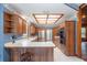 Galley kitchen with wood cabinets and stainless steel appliances at 7545 Ne 58Th Ave, Anthony, FL 32617