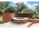 Brick hot tub nestled in a secluded area at 7545 Ne 58Th Ave, Anthony, FL 32617