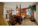 Spacious bedroom with a large bed, dresser, and ceiling fan at 5311 Se 15Th Ct, Ocala, FL 34480