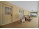 Spacious screened porch with rocking chairs and access door at 5311 Se 15Th Ct, Ocala, FL 34480