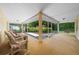 Relaxing screened porch with wicker furniture and backyard view at 5311 Se 15Th Ct, Ocala, FL 34480