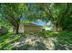 Spacious backyard with lush lawn and mature trees providing shade at 5311 Se 15Th Ct, Ocala, FL 34480