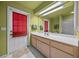 Clean bathroom with a single sink vanity and exterior access at 5311 Se 15Th Ct, Ocala, FL 34480