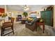 Spacious living room featuring a comfortable leather sofa and a cozy fireplace at 5311 Se 15Th Ct, Ocala, FL 34480