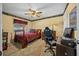 Bedroom with a full-size bed, a workspace, and ceiling fan at 5311 Se 15Th Ct, Ocala, FL 34480