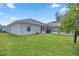 Large backyard with screened patio, grassy area, and partially visible pool at 3967 Se 99Th St, Belleview, FL 34420