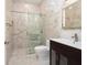 Bathroom with glass shower, toilet and dark vanity at 7578 Nw 33Rd Pl, Ocala, FL 34482