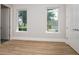 Bright bedroom with hardwood floors and two windows at 7578 Nw 33Rd Pl, Ocala, FL 34482