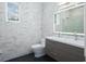 Modern bathroom with double vanity and marble tile at 7578 Nw 33Rd Pl, Ocala, FL 34482