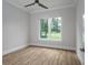 Spacious bedroom with hardwood floors and large window at 7578 Nw 33Rd Pl, Ocala, FL 34482