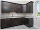 Laundry room with custom cabinetry, quartz countertops and tile flooring at 7578 Nw 33Rd Pl, Ocala, FL 34482