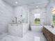 Spa-like bathroom with a large walk-in shower, soaking tub, and marble finishes at 7578 Nw 33Rd Pl, Ocala, FL 34482