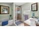 Bathroom with shower, bathtub, vanity, and linen storage at 3967 Se 99Th St, Belleview, FL 34420
