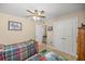 Bedroom with twin beds, ceiling fan and double doors at 3967 Se 99Th St, Belleview, FL 34420