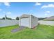 Tan storage shed with roll-up door and a ramp for easy access at 3967 Se 99Th St, Belleview, FL 34420