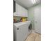 Bright laundry room with washer, dryer, and ample cabinet storage at 3967 Se 99Th St, Belleview, FL 34420