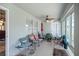 Relaxing screened porch with seating area, ceiling fan, and access to backyard at 3967 Se 99Th St, Belleview, FL 34420