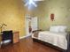 Bedroom with twin bed, desk, and yellow walls at 15700 Se 36Th Ave, Summerfield, FL 34491