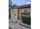 Tan stucco condo building with orange door at 611 Water Rd # 103H, Ocala, FL 34472