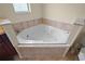 Corner jacuzzi tub with tile surround at 10 Se Chinica Drive, Summerfield, FL 34491