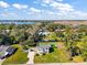 Aerial view showcasing home's curb appeal and waterfront lot at 10 Se Chinica Drive, Summerfield, FL 34491
