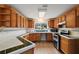 Kitchen with wood cabinets, tile countertops, and stainless steel appliances at 10 Se Chinica Drive, Summerfield, FL 34491