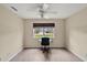Bright home office features a large window, built-in desk, and wood-look flooring at 10 Se Chinica Drive, Summerfield, FL 34491