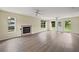 Spacious living room with hardwood floors, fireplace, and plenty of natural light at 10 Se Chinica Drive, Summerfield, FL 34491