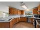 Kitchen with wood cabinets, tile countertops, and stainless steel appliances at 10 Se Chinica Drive, Summerfield, FL 34491