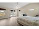 Main bedroom with fireplace, double doors to deck, and ceiling fan at 10 Se Chinica Drive, Summerfield, FL 34491