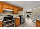 Kitchen with wood cabinets, stainless steel appliances, and view to the backyard at 10 Se Chinica Drive, Summerfield, FL 34491