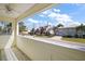 Screened porch with ceiling fan and view of neighborhood at 10 Se Chinica Drive, Summerfield, FL 34491