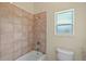 Bathroom with tub, shower, and single window at 10 Se Chinica Drive, Summerfield, FL 34491