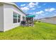 Backyard patio with seating area and green lawn at 1789 Usrey Ct, The Villages, FL 34762