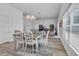 Bright dining area with table and chairs, open to the living room at 1789 Usrey Ct, The Villages, FL 34762