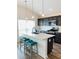 Kitchen features a large island with seating, stainless steel appliances, and dark wood cabinets at 1789 Usrey Ct, The Villages, FL 34762