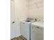 Laundry room with Maytag washer and dryer, and overhead shelving at 1789 Usrey Ct, The Villages, FL 34762