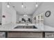 Kitchen sink and island with white countertops at 1789 Usrey Ct, The Villages, FL 34762