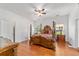 Main bedroom with a large wooden bed, hardwood floors and ample natural light at 14550 Sw 61St Ct, Ocala, FL 34473